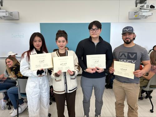 4 Community Nutrition students holding Certificates of Excellence rewards