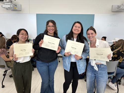 Four Community Nutrition students holding Certificates of Excellence awards