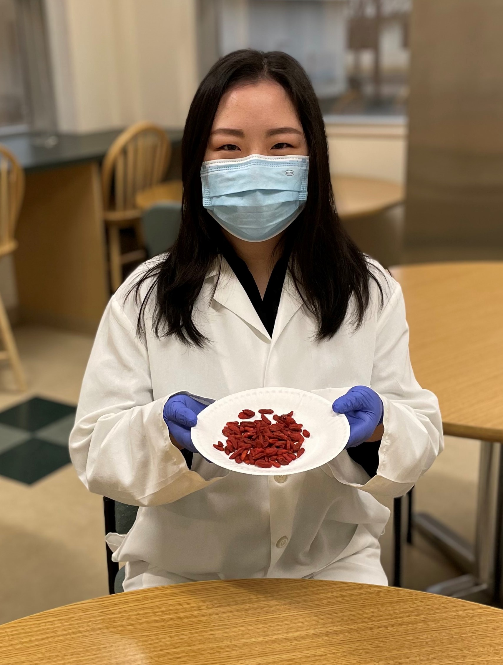 Lead author Xiang Li holding a plate of goji berries