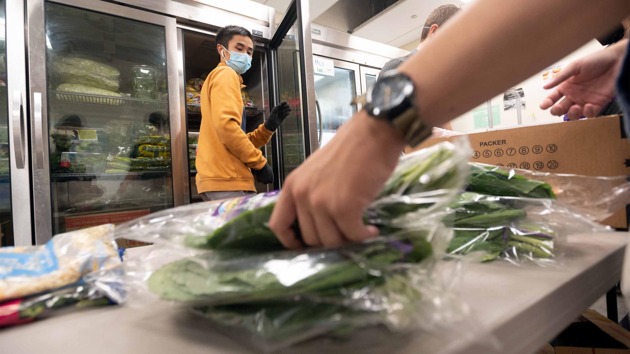 Student turns as hand grabs food on table