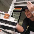 Worker passes out food from AggieEats food truck