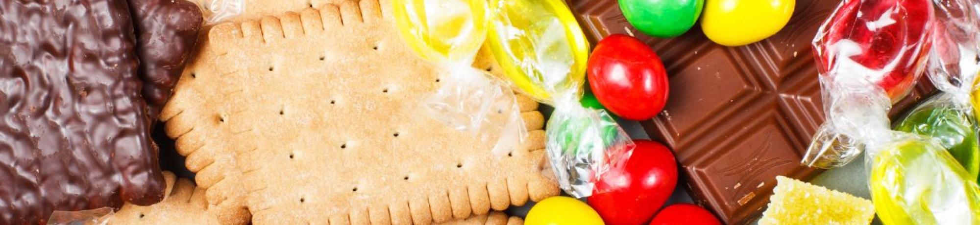 Colorful assortment of candies, chocolates, cookies and gummy sweets.